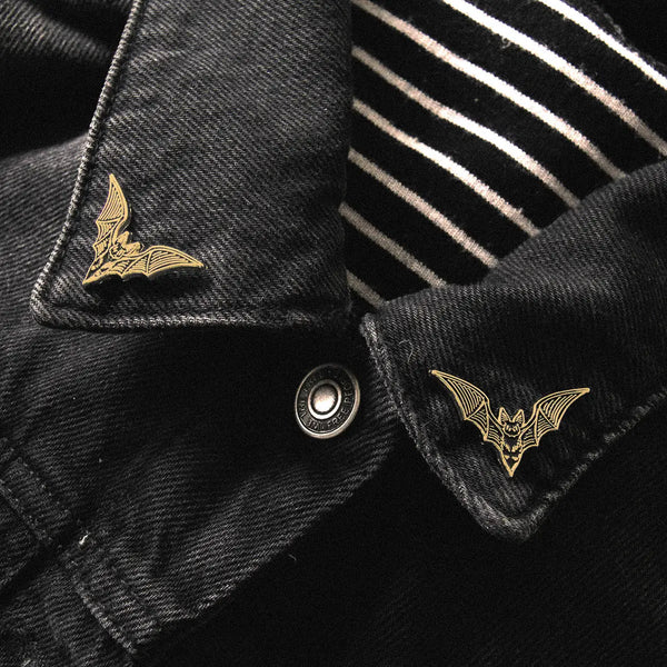 Bat black detailed enameled gold metal clutch-back pin set to fit on collar points. Original design by artist Ectogasm. Shown on collar of black denim jacket 