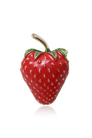 A shiny green and red enameled gold metal brooch in the shape of a strawberry