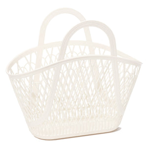 A large creamy white rounded handle bag in a market basket style with a criss-cross pattern and flat base