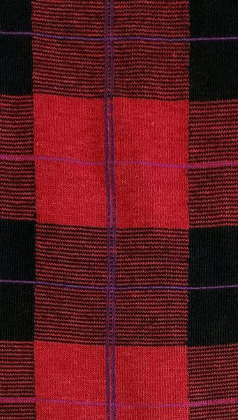 sweater knit tights in a black background plaid with red and bright and dark purples, showing close up fabric swatch