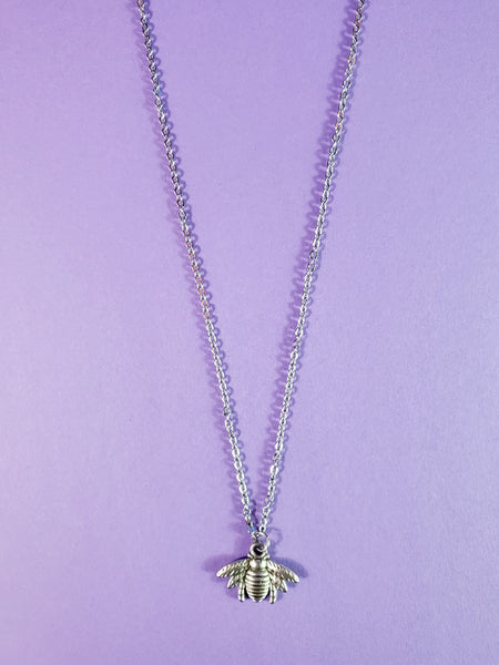 silver metal bee pendant on delicate silver metal link chain
