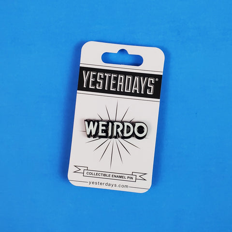 "WEIRDO" text glow in the dark white enameled gunmetal finish metal lapel pin, shown on illustrated cardstock backer packaging