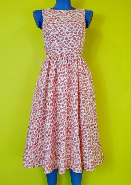 creamy white cotton with red stripey beach umbrella print sleeveless fit & flare knee length dress, shown on mannequin