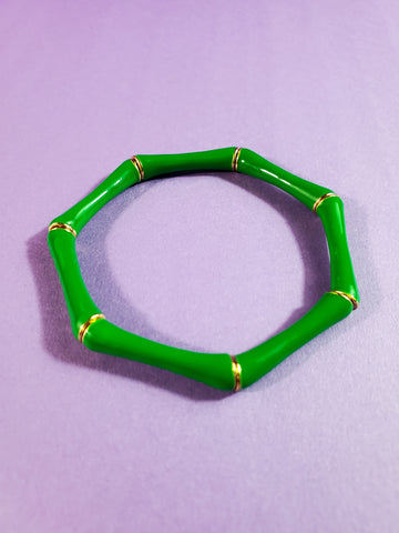 bracelet of bright green enameled gold metal bamboo-like segments strung on clear elastic filament
