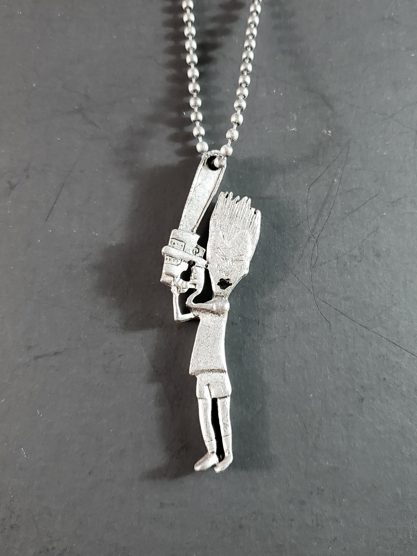 Beavis and Butt-Head deadstock necklace featuring pewter Butt-Head wielding a chainsaw  pendant on 26" ballchain.