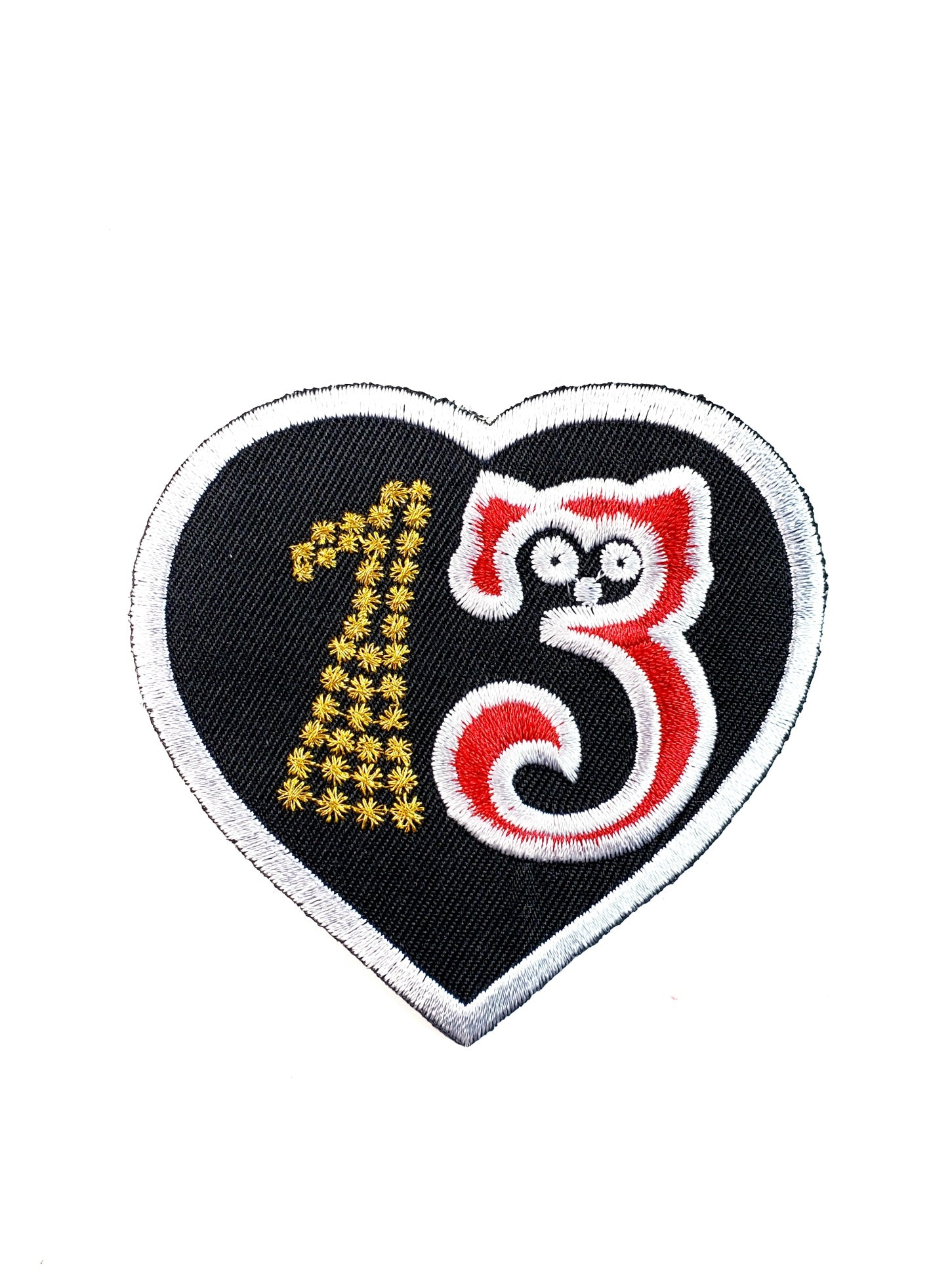 black canvas twill heart-shaped embroidered "13" patch where the silhouette of a cat forms a red, white, and black number 3 while the number 1 is formed by tiny gold stars made of metallic thread