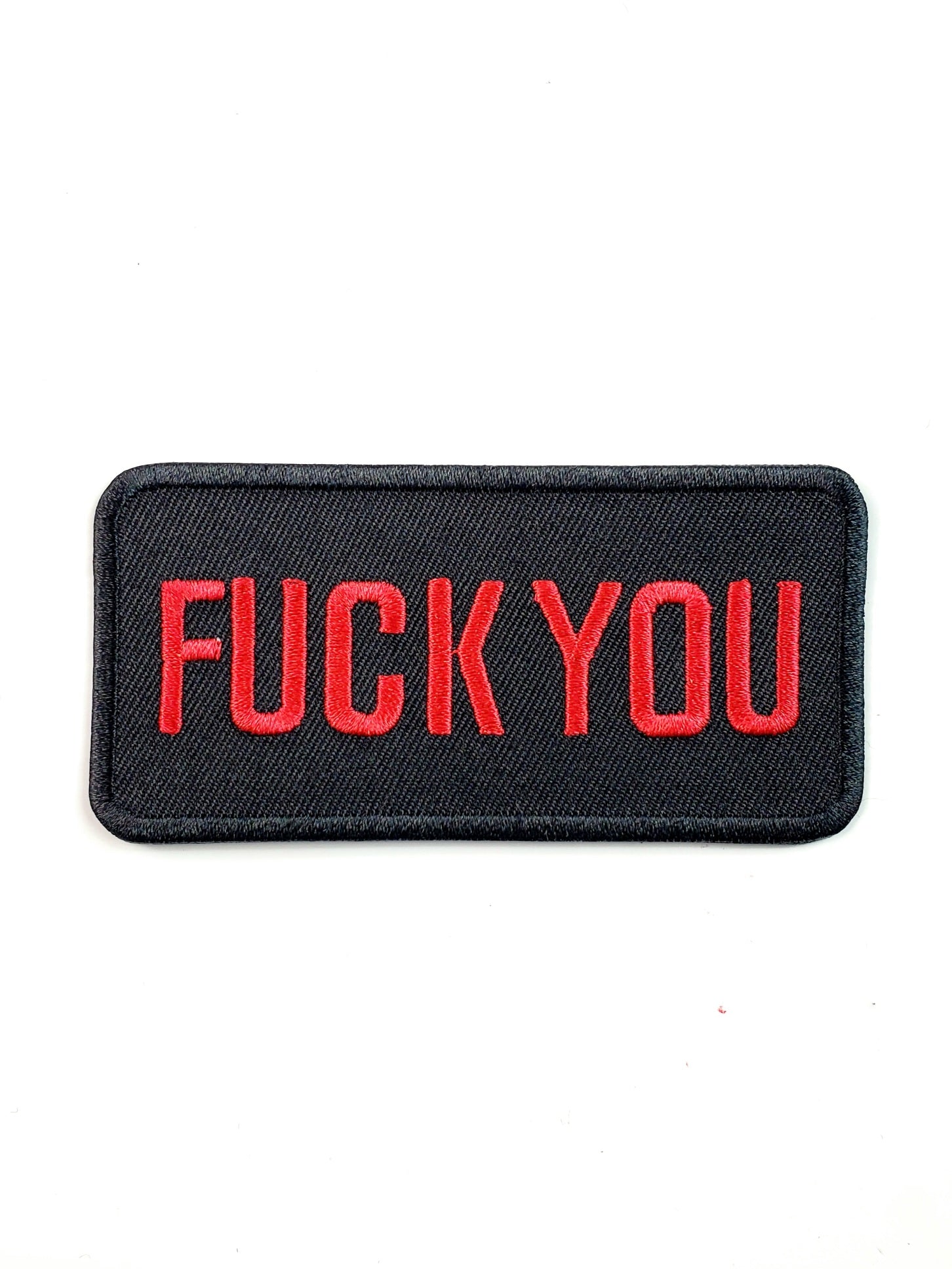 Red stitched "FUCK YOU" text on black canvas twill with black stitched edge rectangular embroidered patch