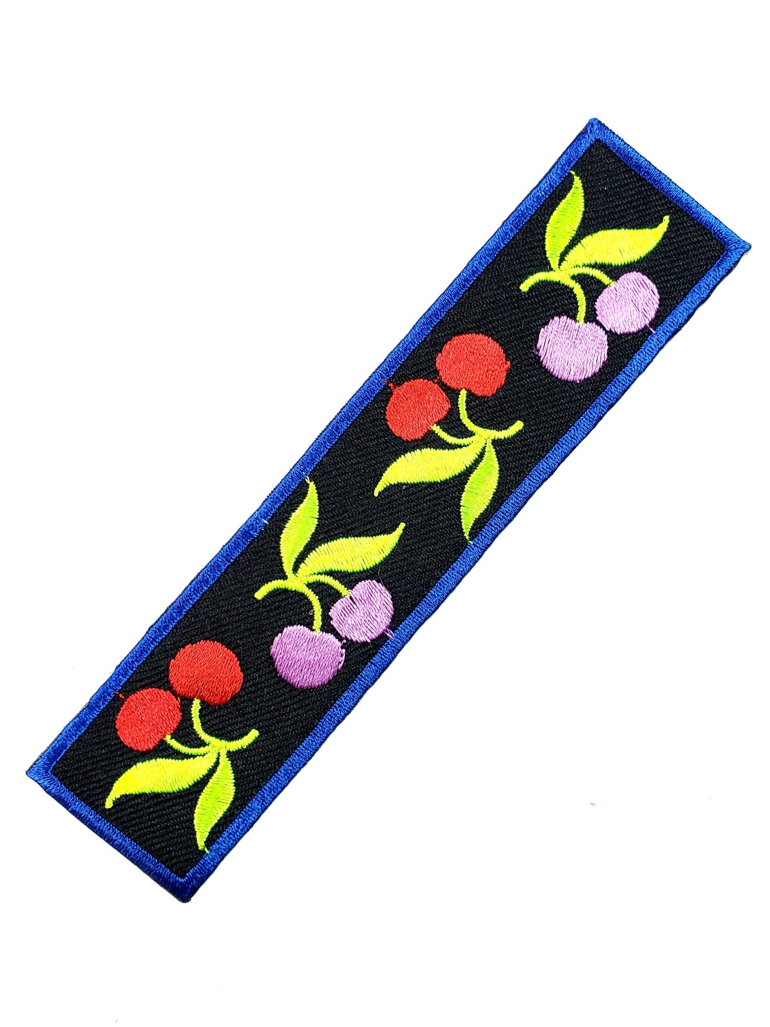 Alternating embroidered pink and red cherry pairs on a rectangular strip of black canvas with blue stitched border