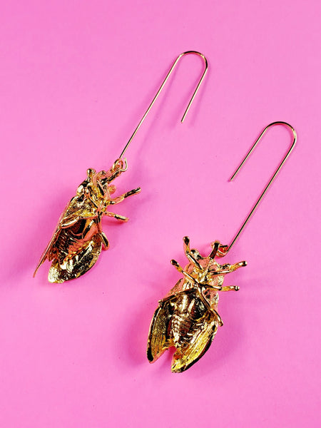 pair of shiny gold metal cicada shaped earrings on long gold wire hooks, showing side and reverse view