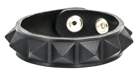 A molded rubber bracelet with a single row of black rubber pyramid studs and silver metal double snap enclosure 