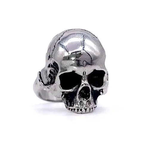 A stainless steel ring of a detailed skull on a solid stainless steel band. Shown at a 3/4 angle facing the right to show detail 