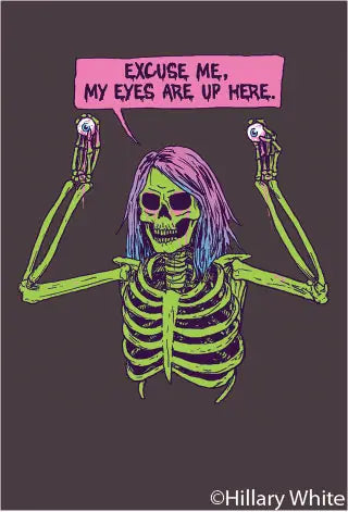 A rectangular magnet of a skeleton with pink and blue ombré hair holding up two eyeballs with a speech bubble captioning “Excuse me, my eyes are up here.”