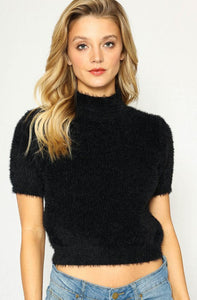 Slightly cropped length short sleeve mock turtleneck "Sweater Girl" style in black, shown on model