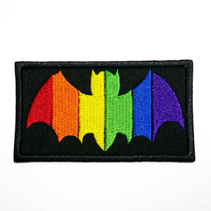 A rectangular black cotton twill patch with a rainbow colored embroidered bat