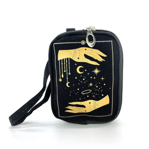 Black canvas rectangular pouch printed with a metallic gold design of a pair of hands and stars of various sizes and an Art Deco style rectangular border. Has two zipper closure compartments, and detachable wristlet strap. Shown from the front