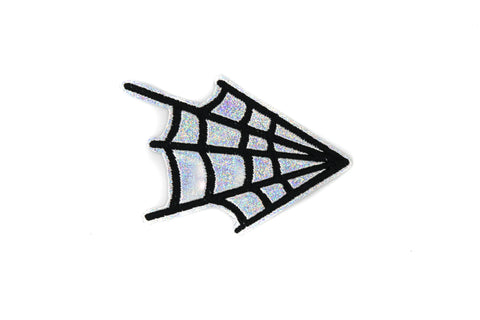 An embroidered patch of a black spiderweb on a silver holographic vinyl background