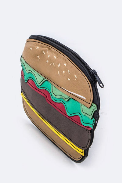 Zippered vinyl pouch in the shape of a cheeseburger with sewn pieces of faux leather in the shape of a bun, lettuce, cheese, burger patty and condiments. It has a black metal zipper along the top. Shown at a 3/4 angle to show width of the pouch
