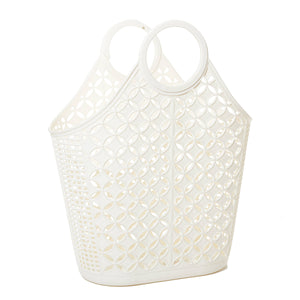 A large creamy white plastic purse with two round interlocking handles, a flat base, and a diamond and grid pattern 