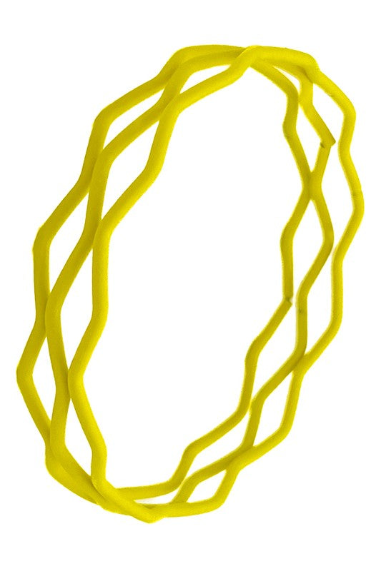 A set of three metal bangles in a wavy zig-zag shape with a bright yellow matte soft-touch coating