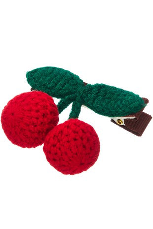 crocheted bright red and green cherries dangling from an alligator style hair clip.