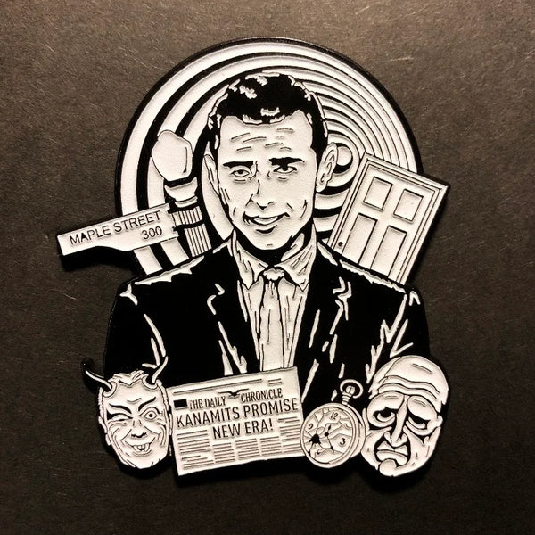 An enamel pin of Rod Sterling from The Twilight Zone surrounded by imagery from various episodes. The pin is in black and white