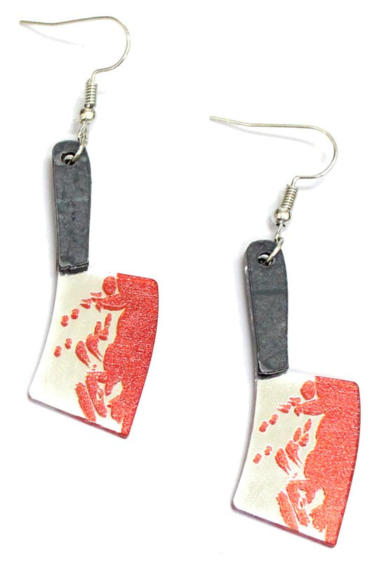 A pair of layered acrylic earrings in the shape of two butcher knives with glittery red blood spattered across them