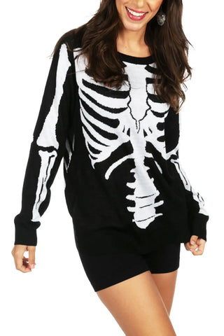 A long sleeved black round neck sweater with a jacquard knit pattern of a skeleton’s bones. Shown on model