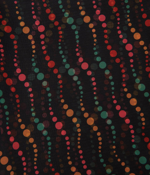 Vintage inspired semi-sheer black and swirling green, red, pink, and yellow dot patterned chiffon rectangular scarf. Close up shot of pattern detail