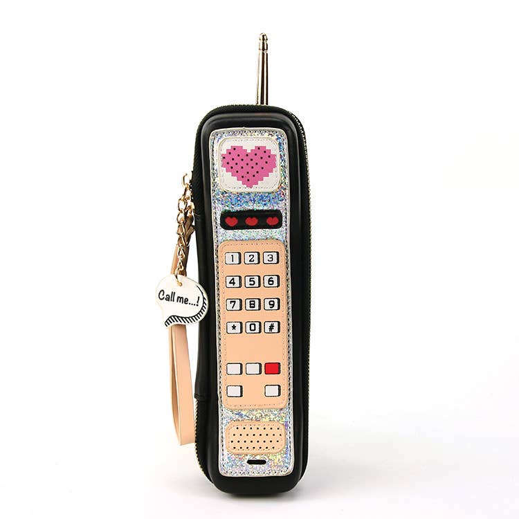 black & peachy-pink vinyl retro 80s era cell phone shaped novelty purse with "Call me..." speech bubble printed charm, silver metal antenna, wristlet strap, and zipper closure