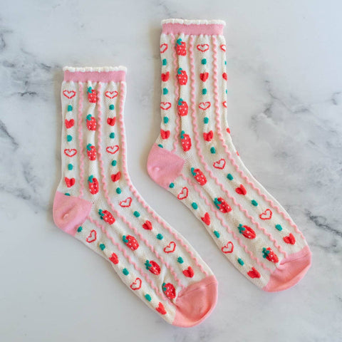 pair cotton knit socks in cream and pink with a textured knit-in pattern of red strawberries and hearts in alternating vertical stripes