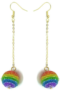 pair of glass rainbow striped ball dangle earrings in a textured finish hanging from long gold chains
