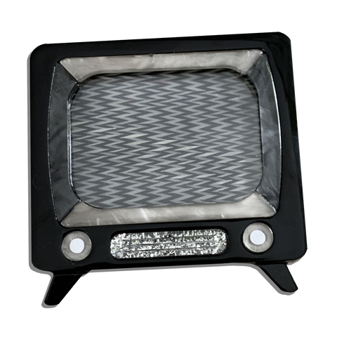 black, grey, and silver glitter "Retro TV" layered laser cut resin brooch that can be worn with snowy static screen as shown, or as a "locket" by inserting a photo in the slot on the top