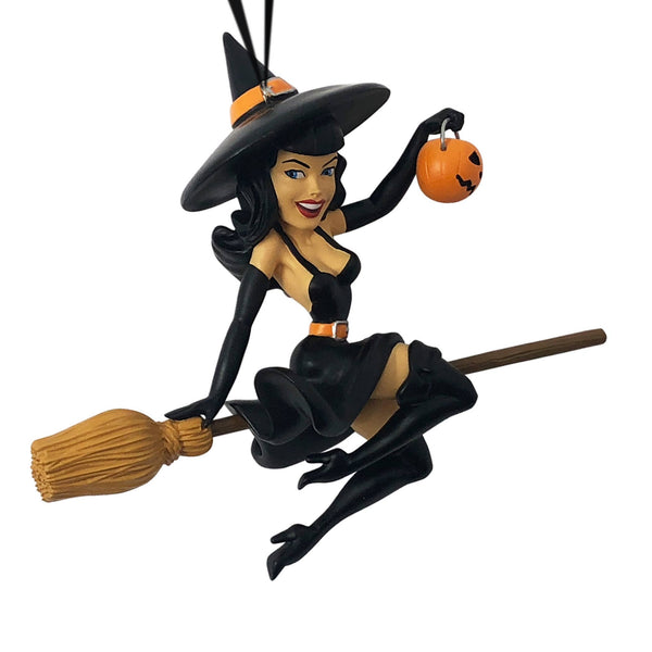 "Midnight Ride" painted resin ornament featuring Bettie Page with witch hat and swinging trick or treat pumpkin pail on a broom