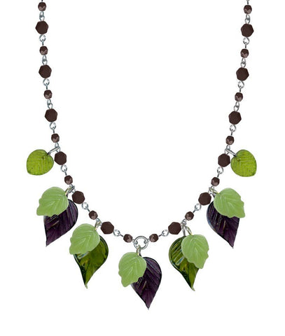 Faceted amethyst glass bead and silver toned metal link necklace with dangling amethyst, and pale and bottle green glass leaves