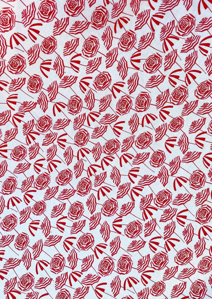 creamy white cotton with red stripey beach umbrella print fabric swatch close up