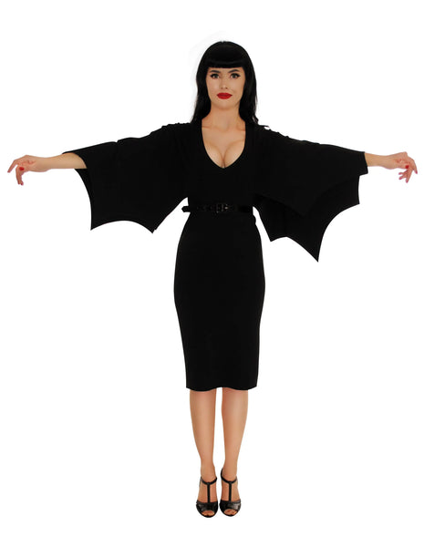 A model wearing the dress with their arms straight at their sides to demonstrate the sleeves