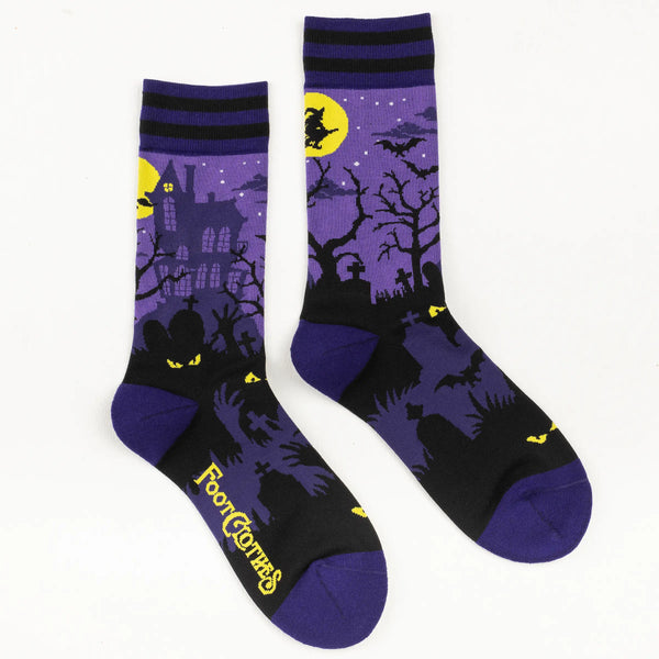 Purple socks with a striped dark purple and black cuff showing a haunted house scene