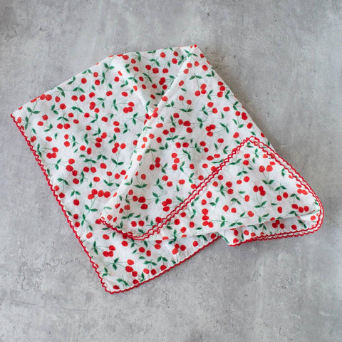 square cotton scarf in white with allover dainty cherry print in red & green and finished with bright red embroidered scallop trim