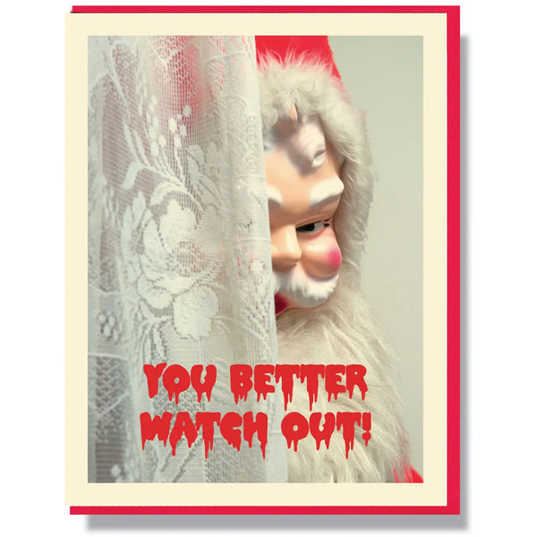 A rectangular holiday greeting card showing a creepy Santa Claus doll peeking out from a white lace curtain with the message “You Better Watch Out!” written in red dripping horror movie font