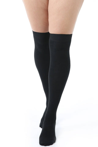 over-the-knee length socks in solid black cotton, shown on model