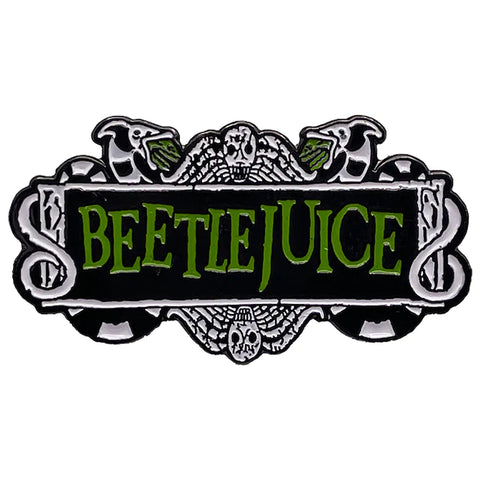 A black, white, and green enamel pin of the logo of the movie Beetlejuice