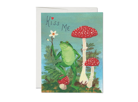 "Kiss Me" text above frog holding flower next to toadstool mushrooms illustrated image heavyweight card stock offset printed note card