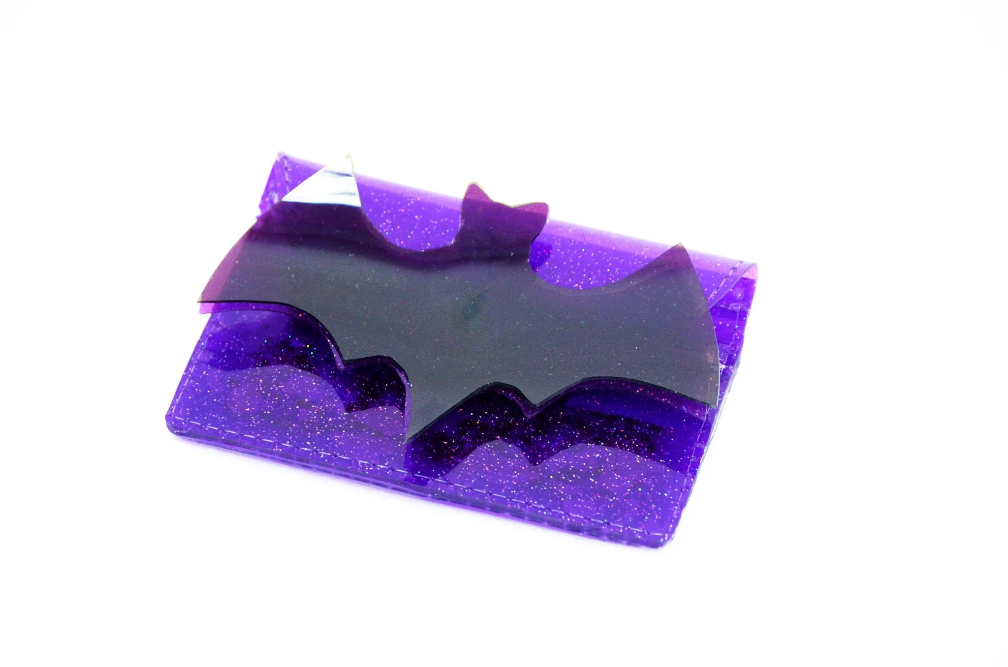A purple glitter vinyl cardholder with a large purple vinyl bat on its fromt