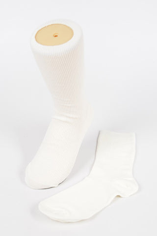 A pair of white crew socks, with one displayed on a mannequin leg to show length