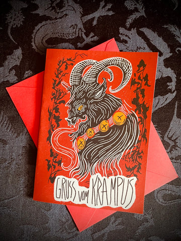 A Christmas card with the message “Gruß vom Krampus” which translates from German into “Greetings from Krampus” on matte card stock with an illustration of Krampus in black, red, and white 