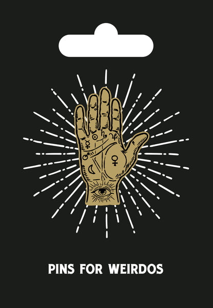 hard enamel pin of a golden hand marked with symbols used in palmistry- including the heart, life, fate, and mercury lines