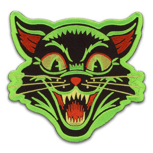 An embroidered patch of a retro style illustration of a black cat with neon green details and border