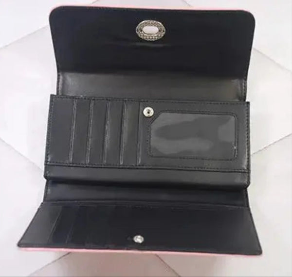 The inside of the wallet in matte black vinyl. It has an inner zippered coin pouch, 9 card slots, and a photo window