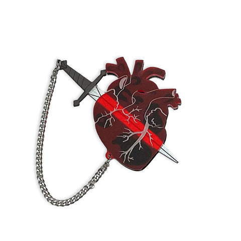 frosty translucent red anatomical heart layered over black laser cut acrylic brooch with removable tiny silver metal chain tethered black & metallic silver sword nestled inside