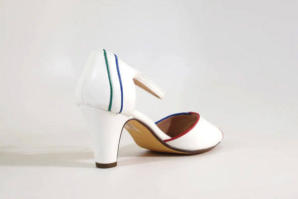 A white pair of peep toe heels with red, yellow, green, and blue piping around the edges of the shoe and back of heel. It has a silver metal buckle on the strap. Shown from the back of the heel